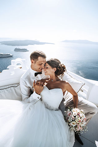 На краю света, жених и невеста на диване с видом на море