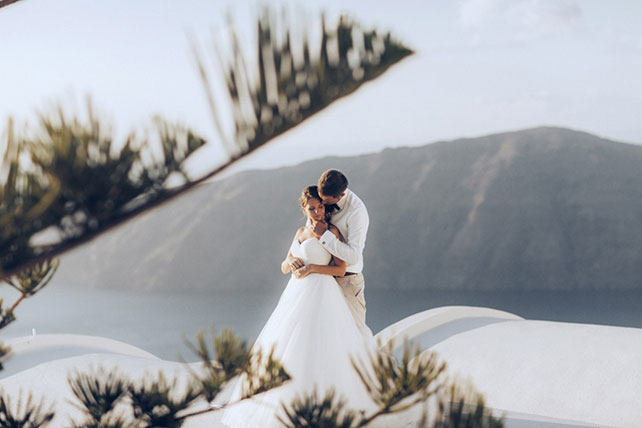 На краю света, жених и невеста на фоне гор и моря