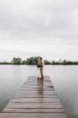 Стильная рустикальная свадьба, жених и невеста на причале