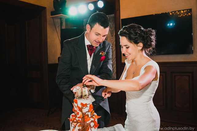 Осенняя свадьба в английском стиле, жених и невеста режут торт