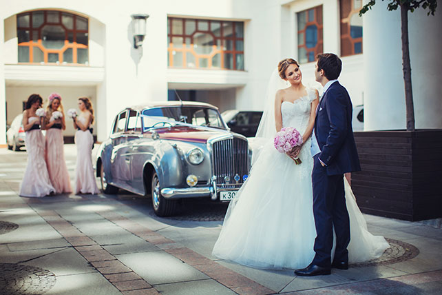 Телевизионная свадьба, жених и невеста у свадебного автомобиля
